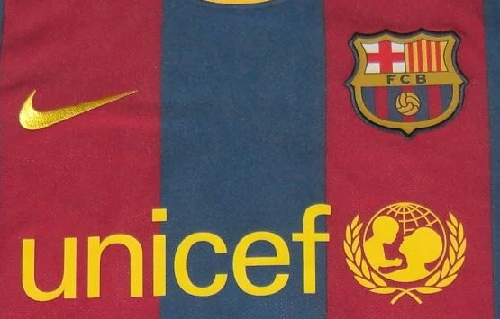 Crest, manufacturer and front-mark detail · crop of the same 2010/11 shirt photograph